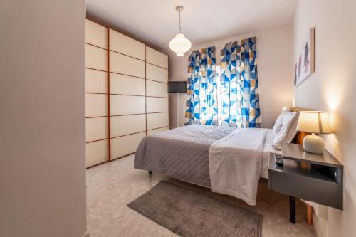 a bedroom with a bed and a desk and a window at Luisa Flat - Metro Basilica San Paolo in Rome