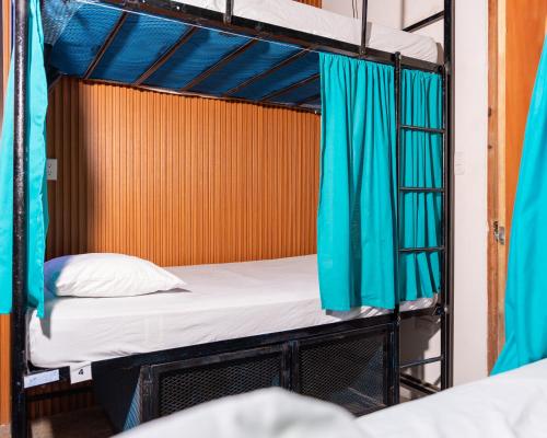 a couple of bunk beds in a room at Surf Town Hostel in San Juan del Sur