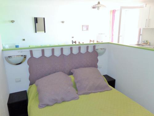 une chambre avec un lit avec deux oreillers dessus dans l'établissement CAP CORNICHE studio avec espace nuit, à Sète