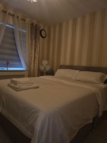 Schlafzimmer mit einem großen weißen Bett und einem Fenster in der Unterkunft Comfortable Short Stay in Dublin in Dublin