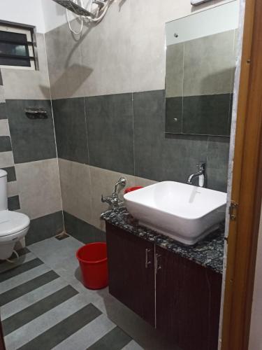 a bathroom with a sink and a toilet at Rieva Residency in Kottayam