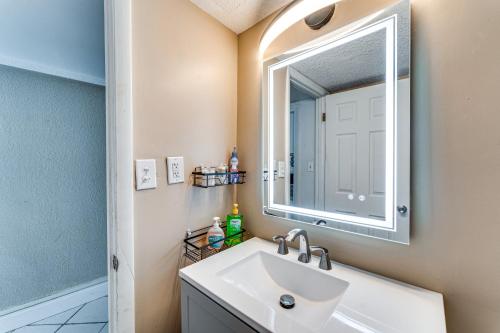 a bathroom with a sink and a mirror at Daytona Beach Resort Studio with Beach Access! in Daytona Beach