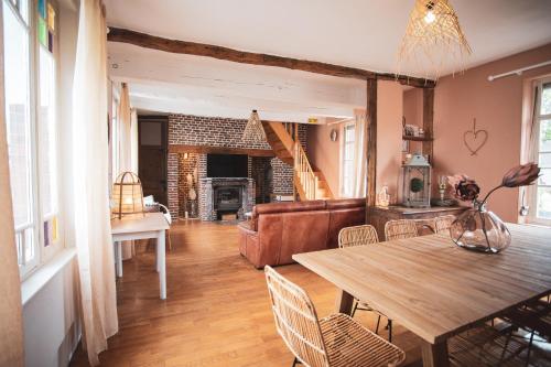 un salon avec une table et un canapé dans l'établissement Gite 15 personnes Ailly le Haut clocher, à Ailly-le-Haut-Clocher
