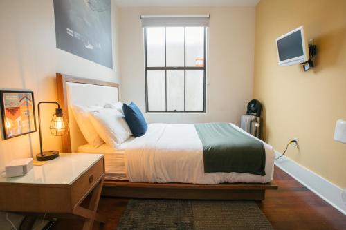 a bedroom with a bed and a window at Commodore Hotel in Astoria, Oregon
