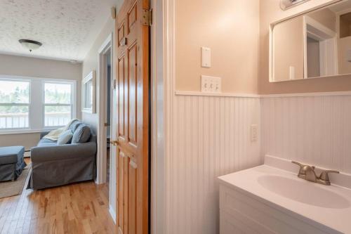 a bathroom with a sink and a mirror at Dreamy Lakefront View Retreat House on Melissa Ave in Terence Bay