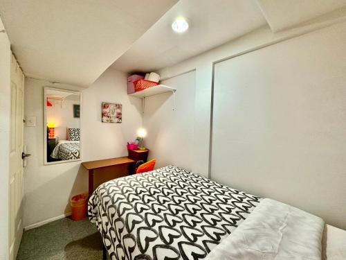 a small bedroom with a bed and a mirror at Private Tiny Room on the 1st Floor with Shared Bathroom near Airport and Downtown Seattte in Seattle