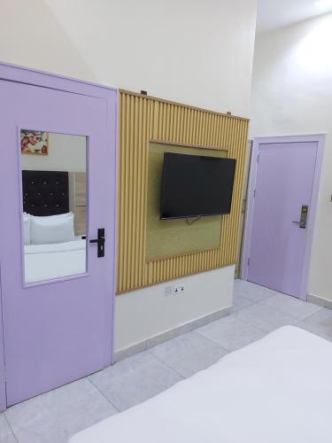 a room with a flat screen tv on a wall at Soulmate Hotels & Suites in Lagos
