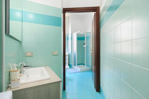 Baño azul con lavabo y espejo en C. Buenos Aires - Stazione centrale, en Milán