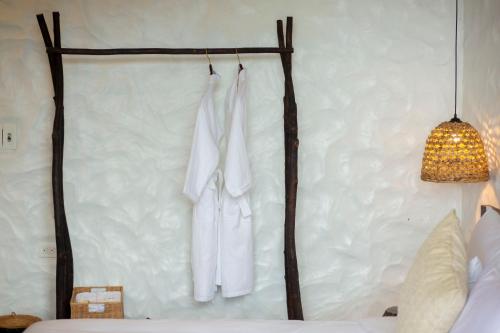 a bedroom with white towels hanging on a wall at Black Ship Sapa in Sa Pa