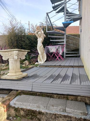 a statue of a woman standing on a wooden deck at Le moderne pornic in Pornic