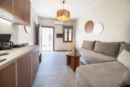 a living room with a couch and a kitchen at Casa di Demezzo in Sitia