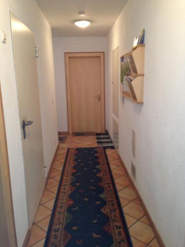 a hallway with a door and a rug on the floor at Ferienwohnung Moritz in Kaunertal