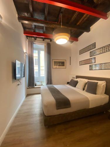 a bedroom with a large bed and a television at Casa Leoncino B&B in Rome