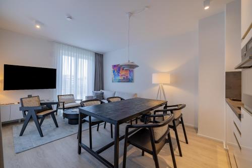 a dining room and living room with a table and chairs at ATLANTIC Grand Hotel Travemünde in Travemünde
