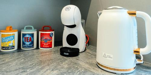 a white blender sitting on top of a counter at Modern 3 Bedroom home. A perfect base for Golfers in Ladybank