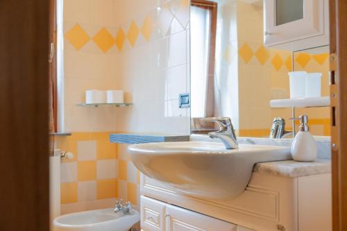 a bathroom with a sink and a toilet at Mara House, Fino del Monte Ospitar in Fino del Monte