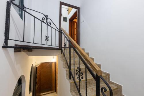 a stairway with a wooden door and a stair railing at Bubamara house in Belgrade