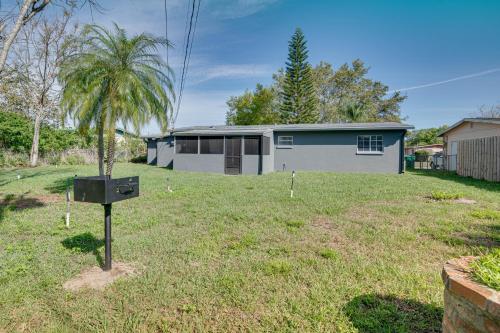 a house with a tree in the yard at Cocoa Home with Large Yard 3 Mi to Indian River! in Cocoa
