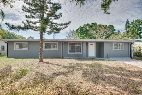 a house with a tree in front of it at Cocoa Home with Large Yard 3 Mi to Indian River! in Cocoa