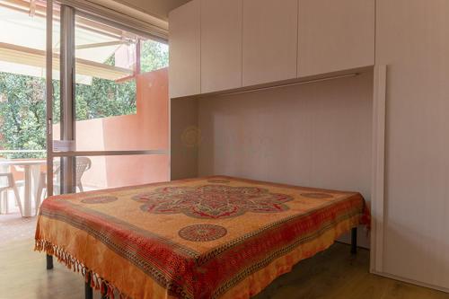 a bed in a room with a large window at BOLINA e FIOCCO in Follonica