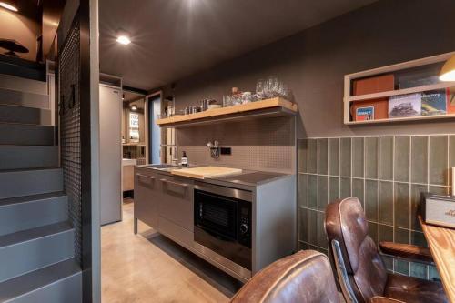 a kitchen with a counter and a stove top oven at Schmalshuus Module in Luxembourg