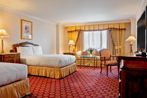 a hotel room with two beds and a desk at Grand America Hotel in Salt Lake City