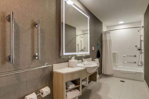 een badkamer met een wastafel, een spiegel en een douche bij SpringHill Suites by Marriott Stillwater in Stillwater