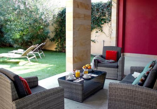 two images of a patio with chairs and a table at Best Western Plus Le Lavarin in Avignon
