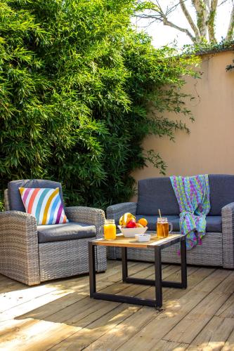 a patio with two couches and a coffee table at Best Western Plus Le Lavarin in Avignon
