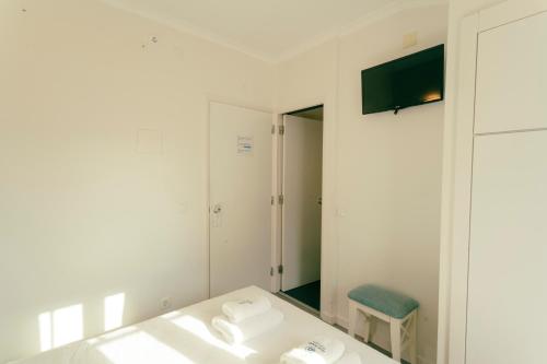 a white bathroom with a sink and a mirror at Best Houses Portugal Residence in Peniche