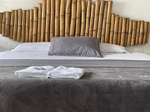 a bed with two towels on top of it at Hostel Once Once in Villa de Leyva