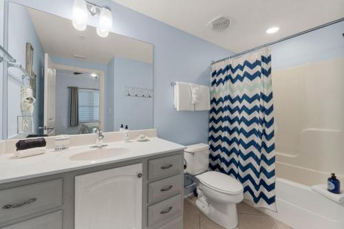 a bathroom with a sink and a toilet and a shower at Palazzo #505 by Nautical Properties in Panama City Beach