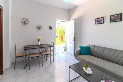 a living room with a couch and a table at Beachside Apartment-1 in Afantou