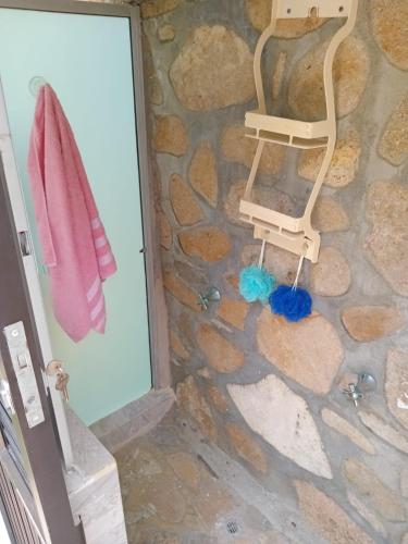 a bathroom with a rocking chair and a towel at Sharick Beach House in Tubará