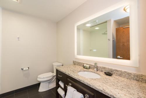 a bathroom with a sink and a toilet and a mirror at Kwataqnuk Resort & Casino in Polson
