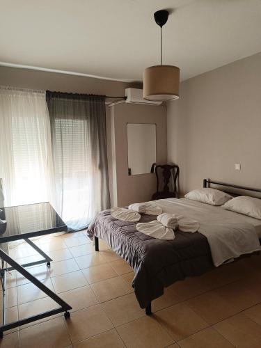 a bedroom with a bed with towels on it at Kalvou Flat2 in Thessaloniki