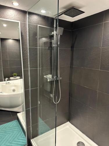 a shower with a glass door in a bathroom at The Inverleither in Edinburgh
