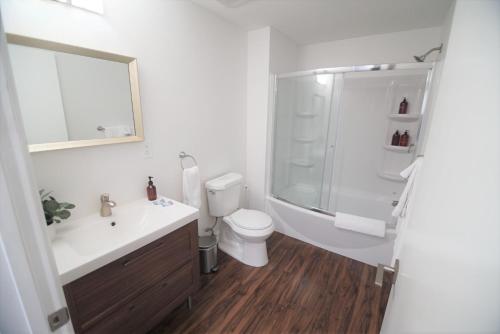 a bathroom with a toilet and a sink and a shower at The Lofts on Clematis 405 Downtown West Palm Beach in West Palm Beach