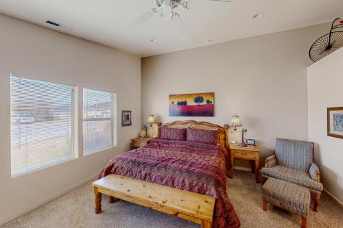 a bedroom with a bed and a chair at Rim Village H4 in Moab