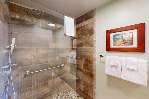 a bathroom with a shower with a glass door at Rim Village H4 in Moab