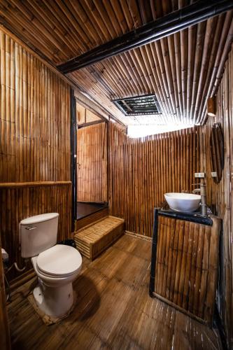 a wooden bathroom with a toilet and a sink at Eco Lanta Hideaway Beach Resort in Ko Lanta