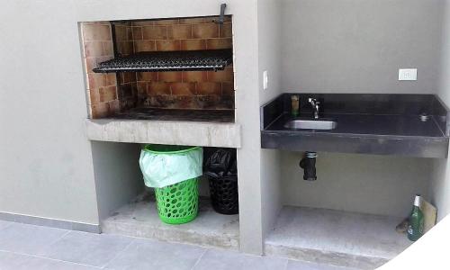 a kitchen with a sink and a trash can at Arevalo 2700 - Las Cañitas in Buenos Aires