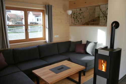 a living room with a couch and a fireplace at Beim Winkel Max in Trauchgau