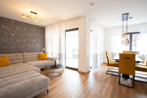 a living room with a couch and a table at Siebenschläfer Appartements in Eging am See