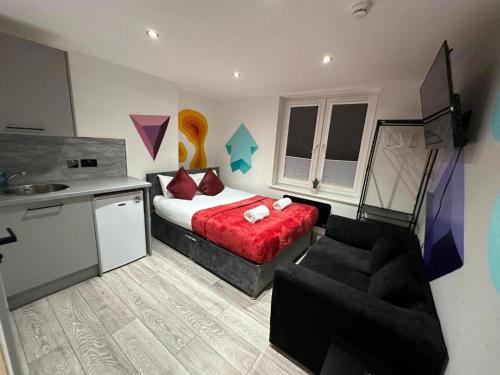 a bedroom with a bed and a chair and a sink at Stunning 1-Bed Apartment in Lewisham SE14 in London