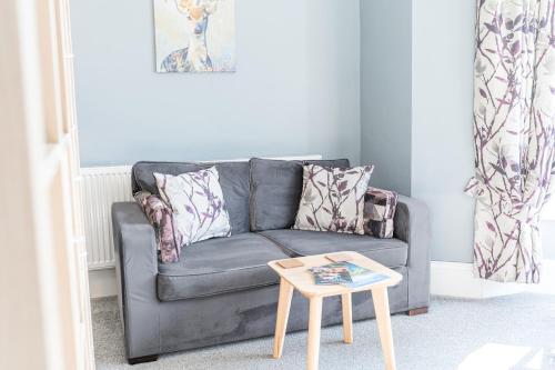a living room with a couch and a coffee table at The Apartments Coniston in Coniston