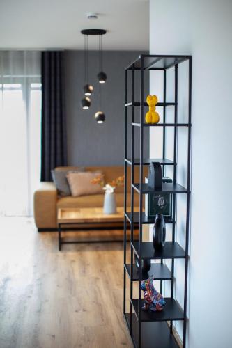 a living room with a couch and a shelf at Siebenschläfer Appartements in Eging am See