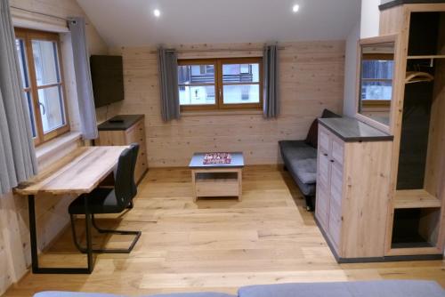 a tiny house with a couch and a table at Beim Winkel Max in Trauchgau