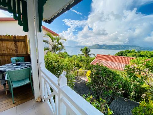 a balcony of a house with a view of the ocean at Anoli Lodges in Sainte-Anne
