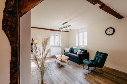 a living room with a couch and a table at Résidence Les Charmes in Boofzheim